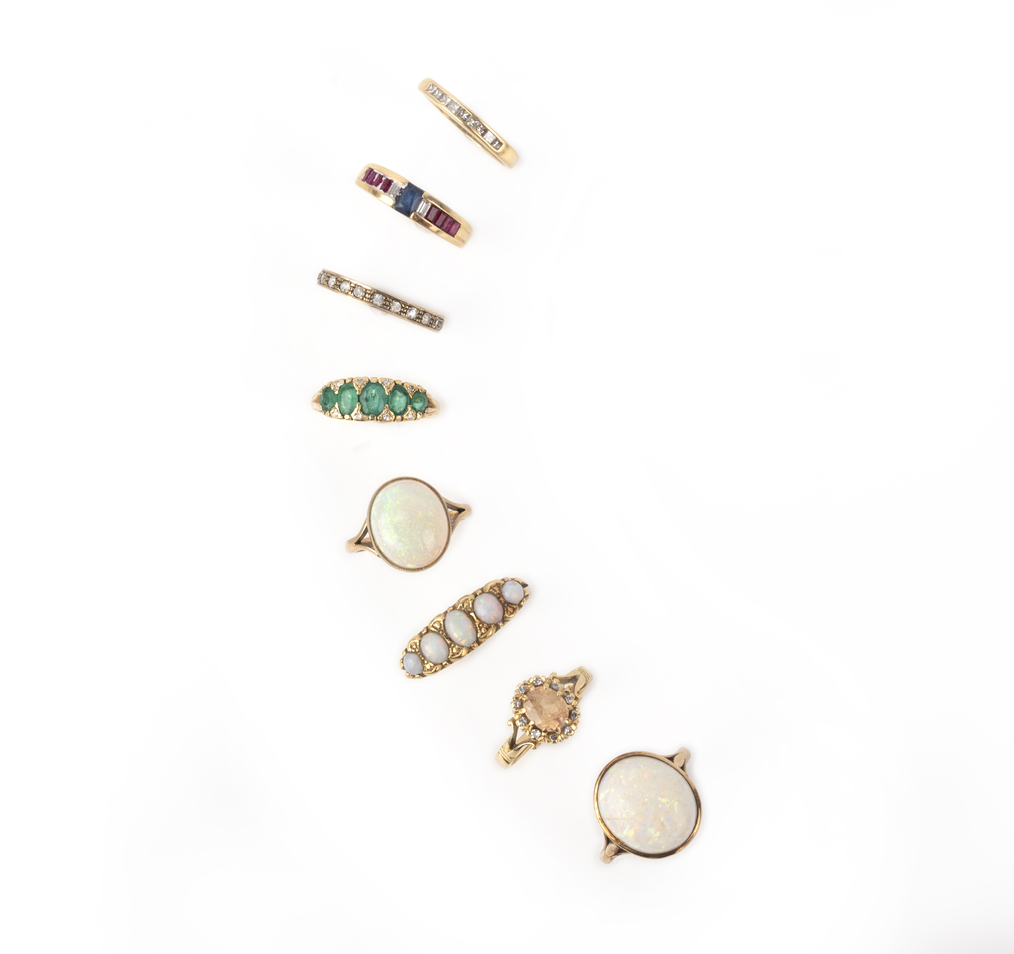 A collection of 8 gem-set gold rings, including an opal five stone ring in carved yellow gold mount,