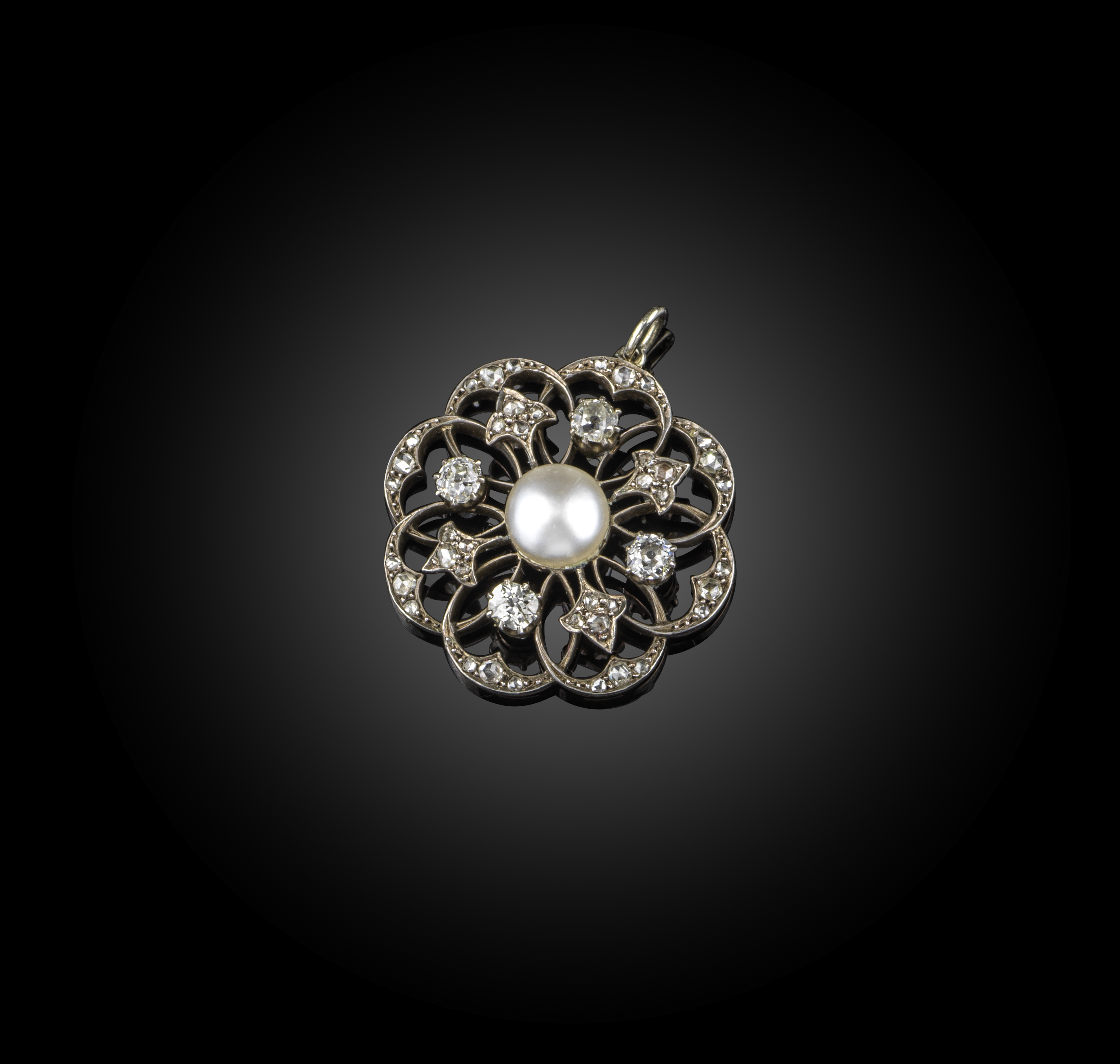 A natural pearl and diamond pendant, circa 1900, designed as an abstract open work flower,