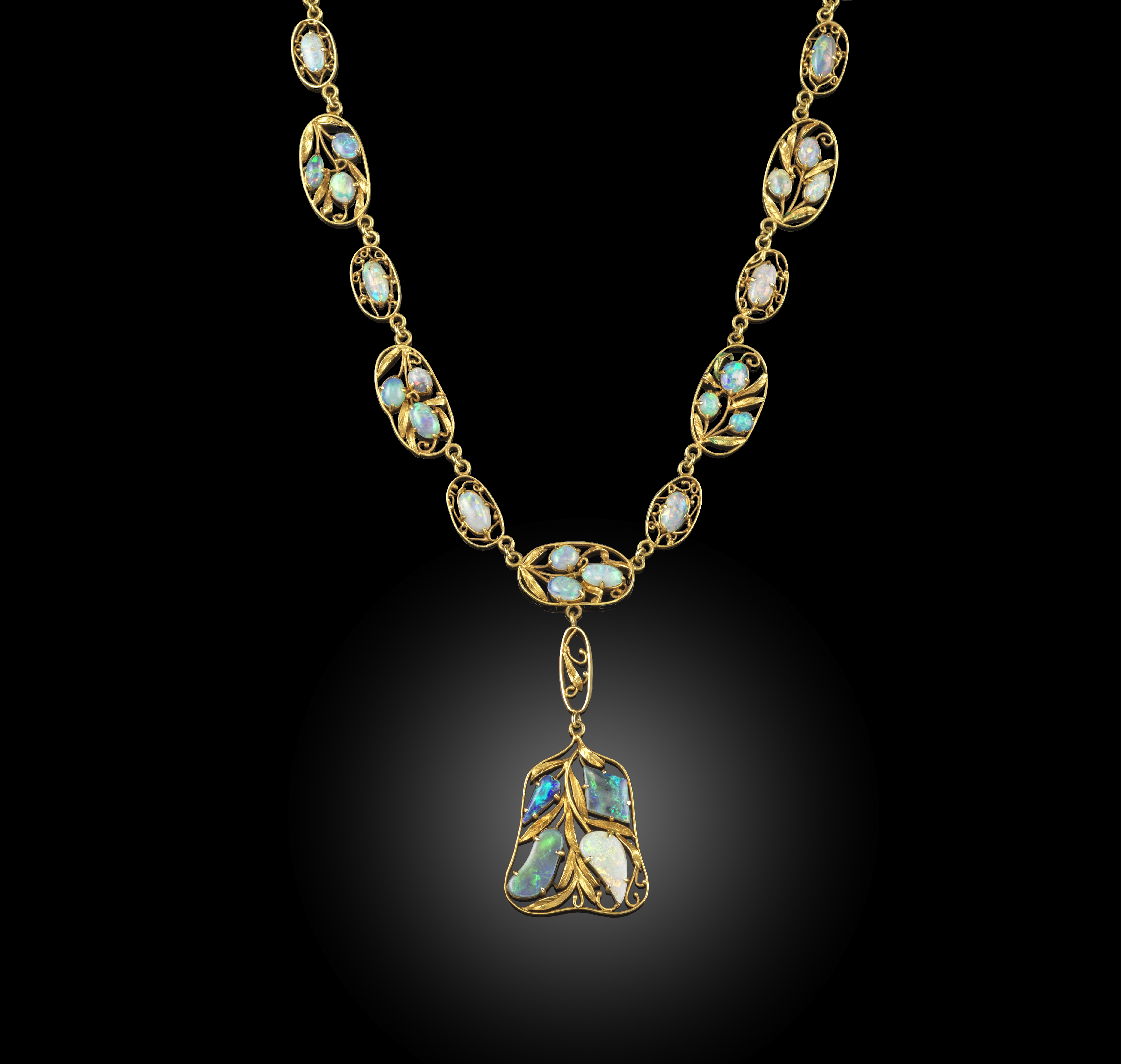 An Arts and Crafts opal necklace, early 20th century, designed as a series of oval foliate links set