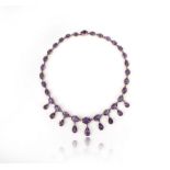 A Victorian amethyst riviere necklace, the oval graduated amethysts in gold cut-down collets suspend