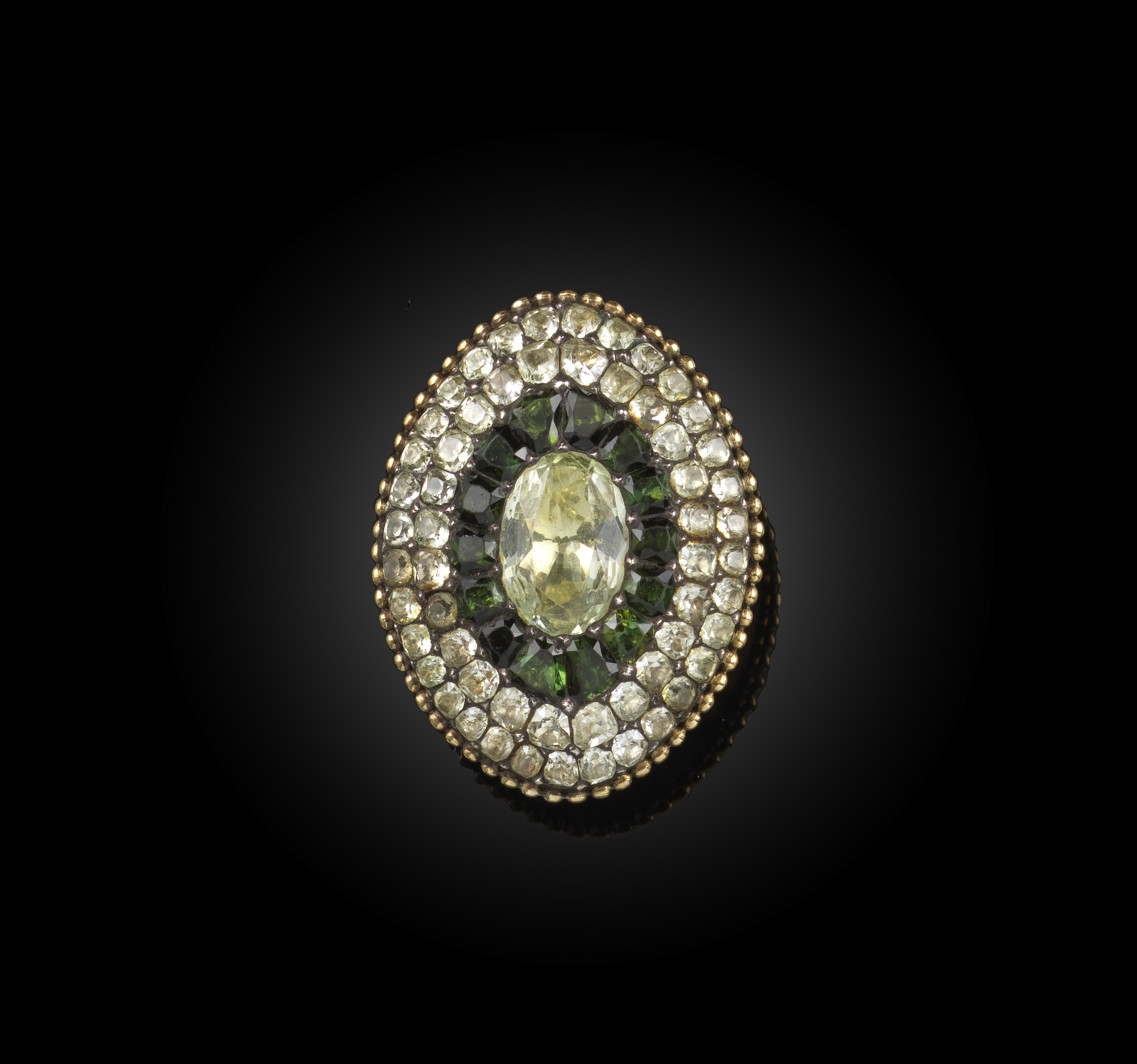 A chrysolite, tourmaline and heliodor ring, Portugal, 19th century, of navette outline with a beaded