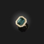An indicolite tourmaline and diamond ring, claw-set with a step-cut deep greenish blue tourmaline