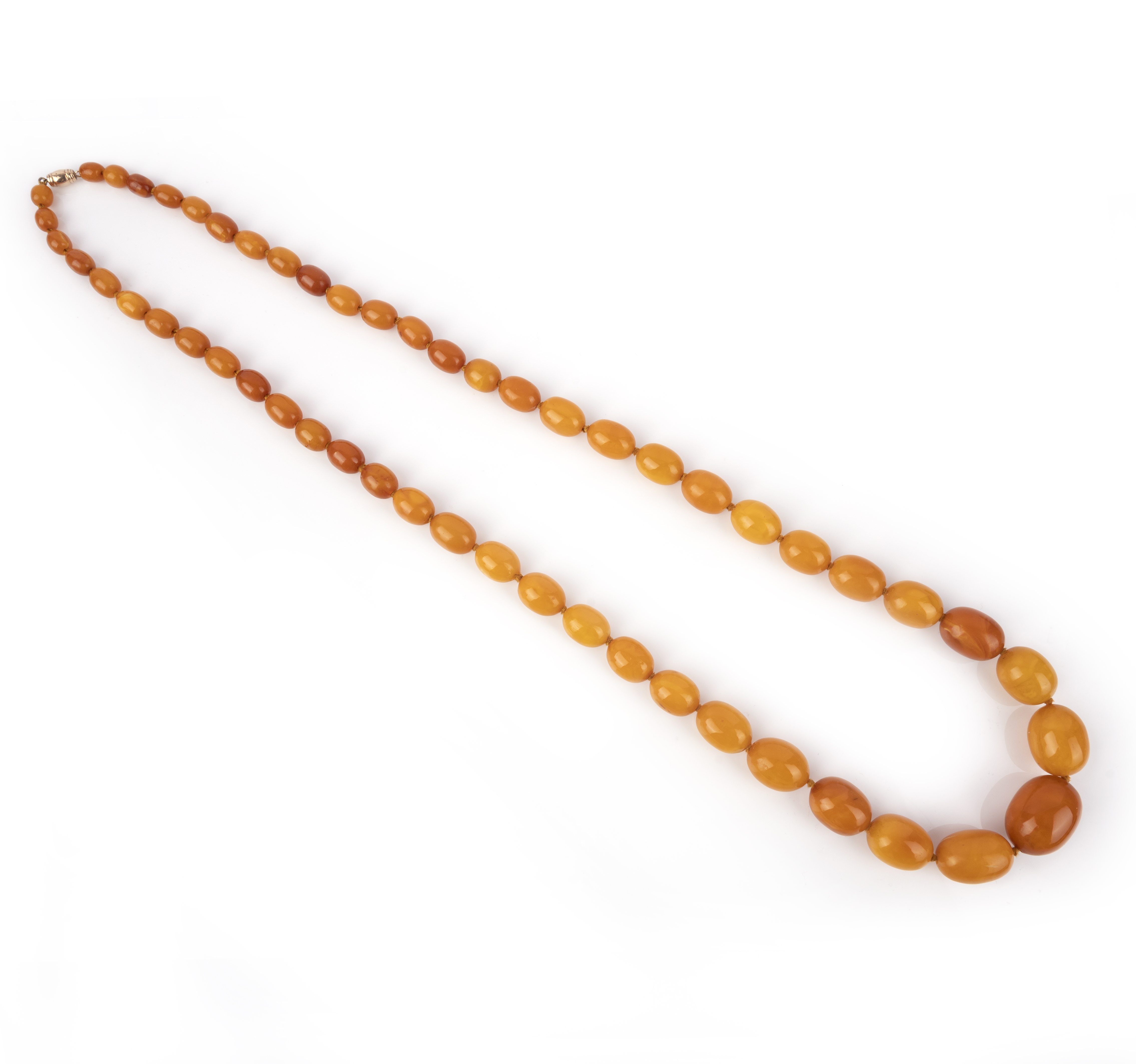 An amber bead necklace, composed of graduated oval amber beads, the largest measuring 2.7 x 2.0 x