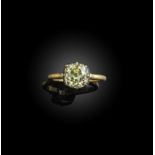 A diamond solitaire ring, set with a cushion-shaped diamond of yellow tint weighing 2.96 carats,