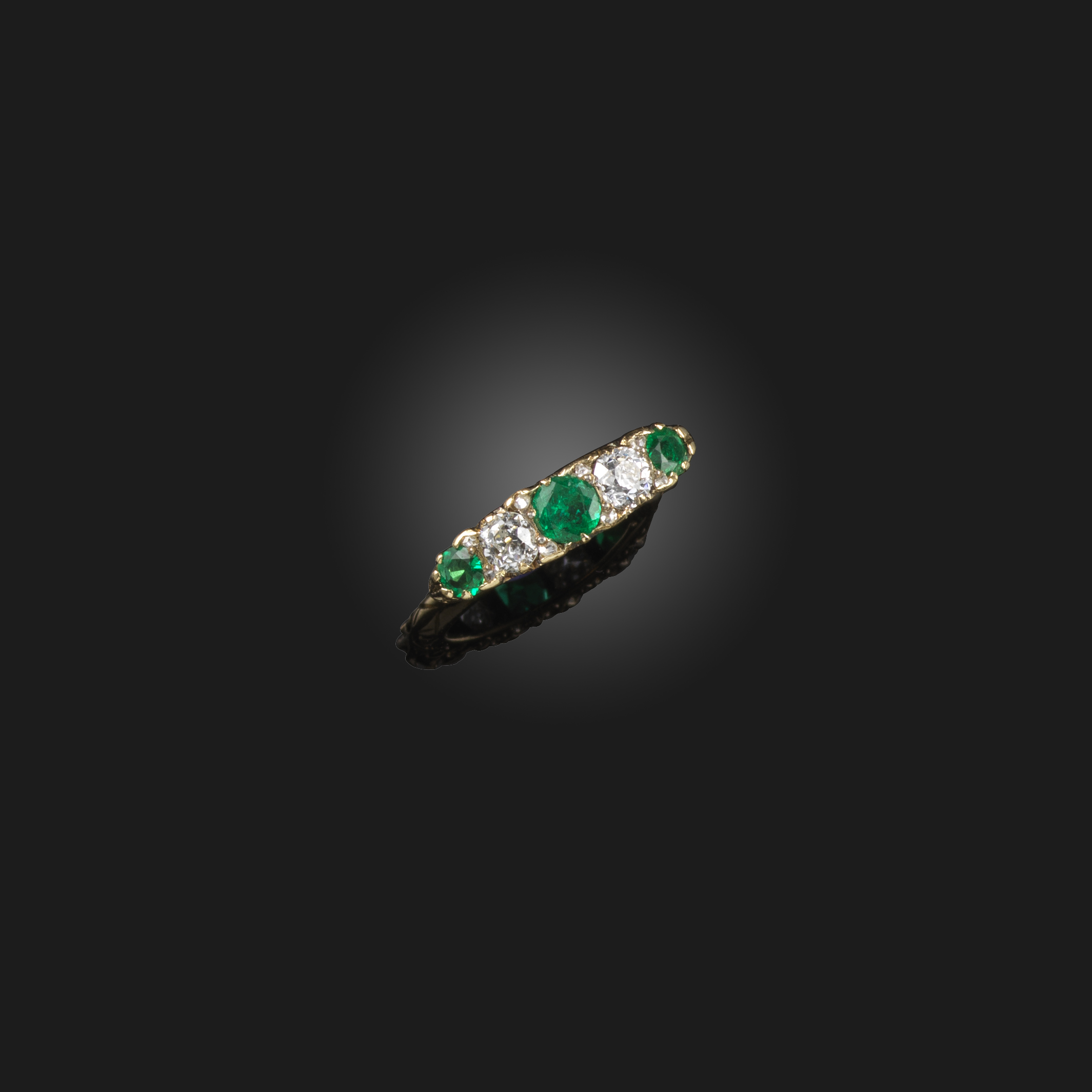 A Victorian emerald and diamond five-stone ring, late 19th century, set with three circular-cut