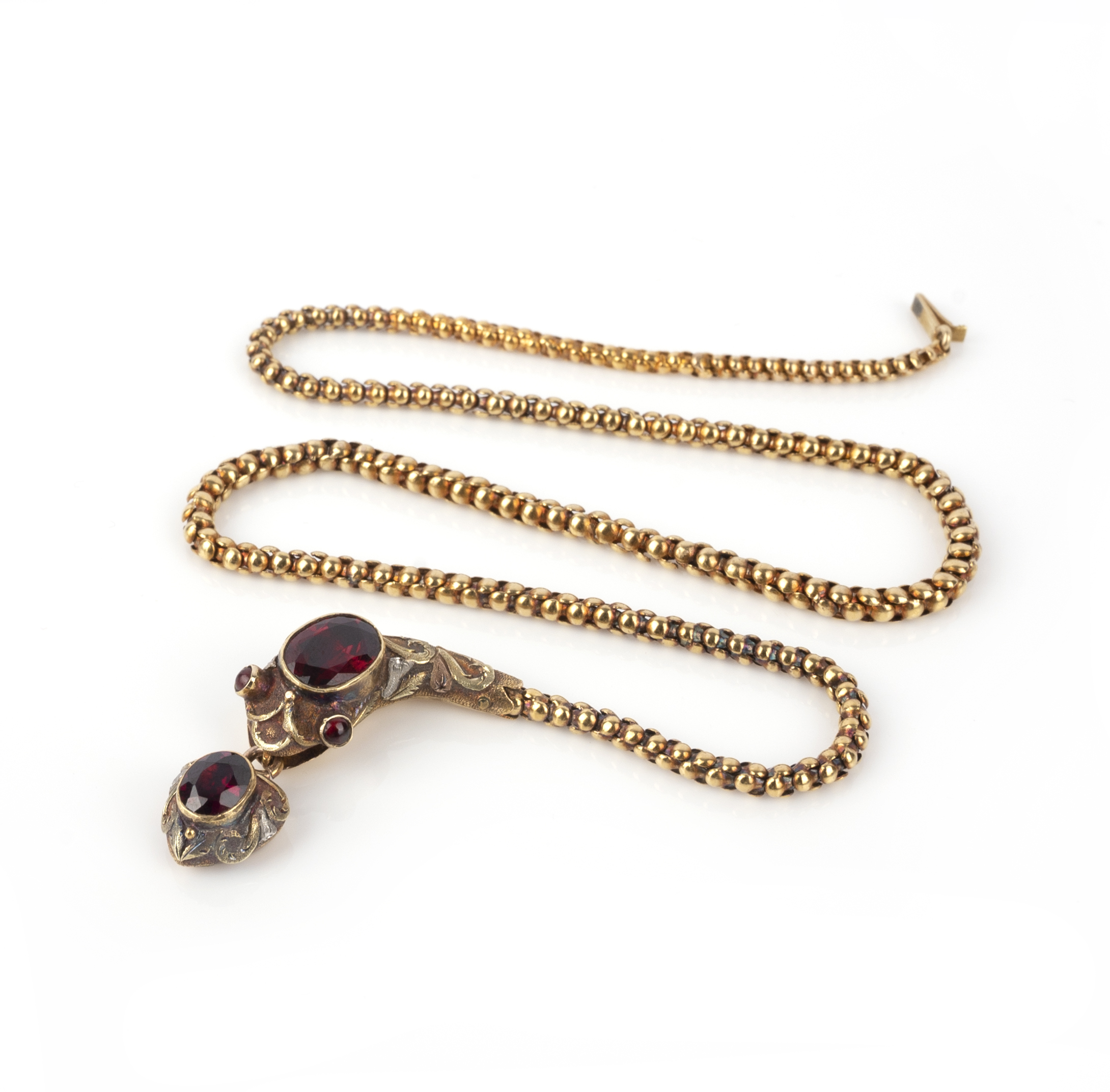 A garnet snake necklace, 19th century, designed as an articulated snake, its body of gold linking,