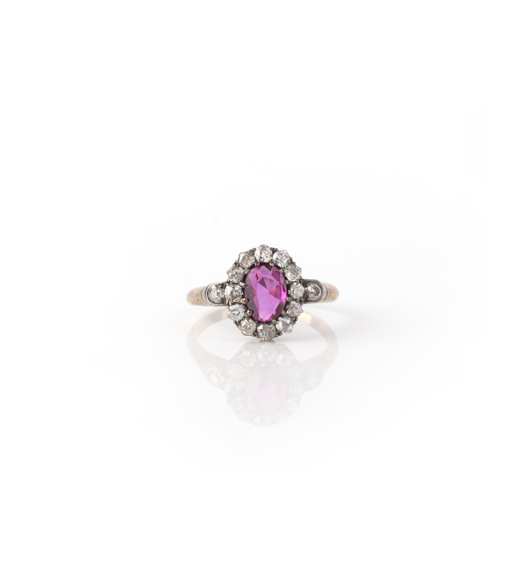 A late 19th century ruby and diamond cluster ring, the oval ruby set within a surround of old - Image 2 of 2