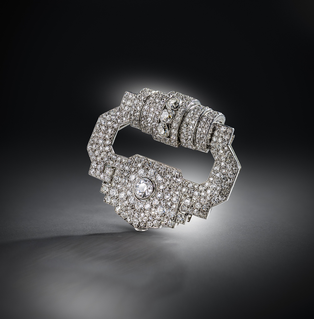 Cartier, an Art Deco diamond clip brooch, circa 1930, designed as a stylised buckle, the top