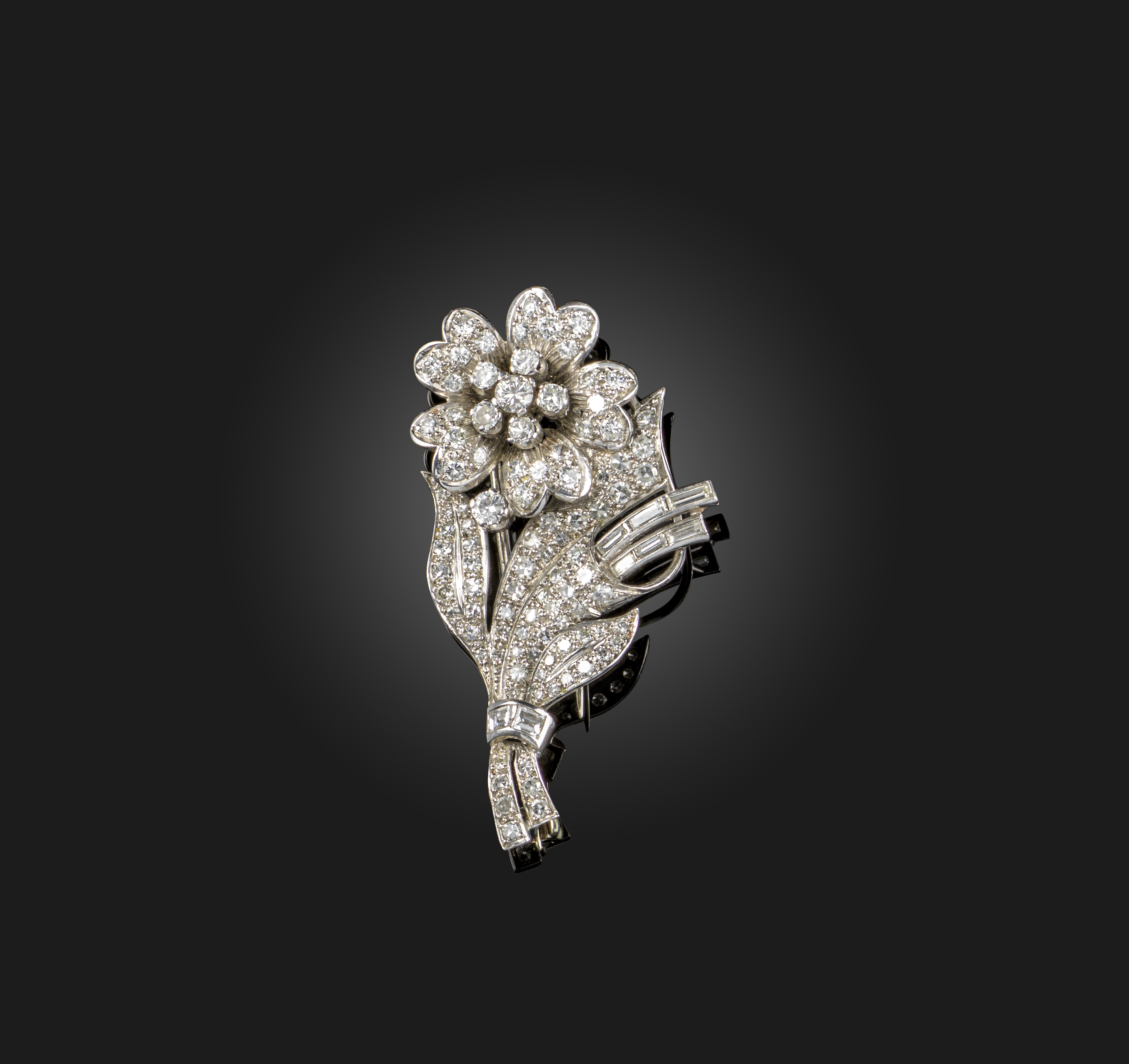 A diamond foliate brooch, set overall with graduated circular-cut and baguette-shaped diamonds in