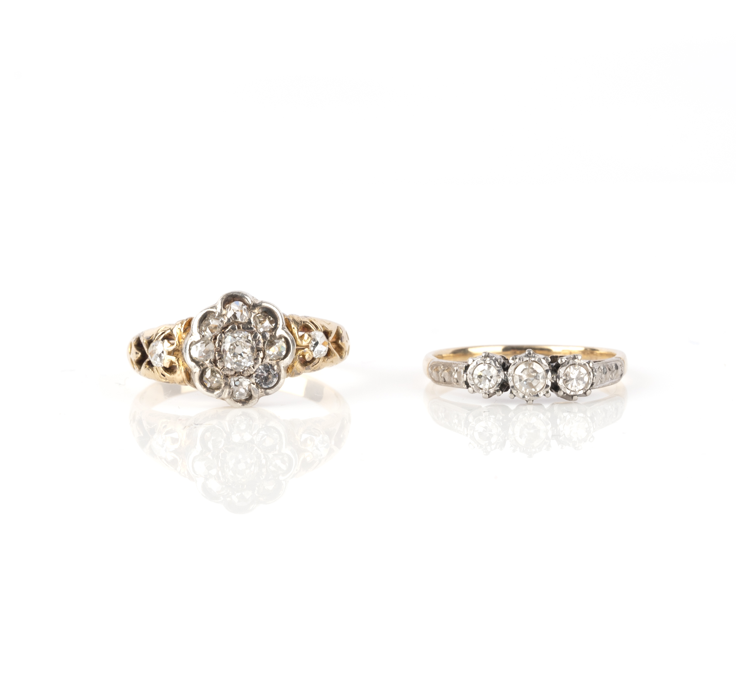 Two diamond rings, comprising: one of cluster design, set with cushion-shaped diamonds, size Q 1/