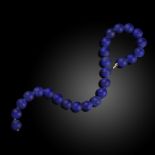 A fine lapis lazuli necklace, designed as a single row of lapis lazuli beads measuring 16.5mm