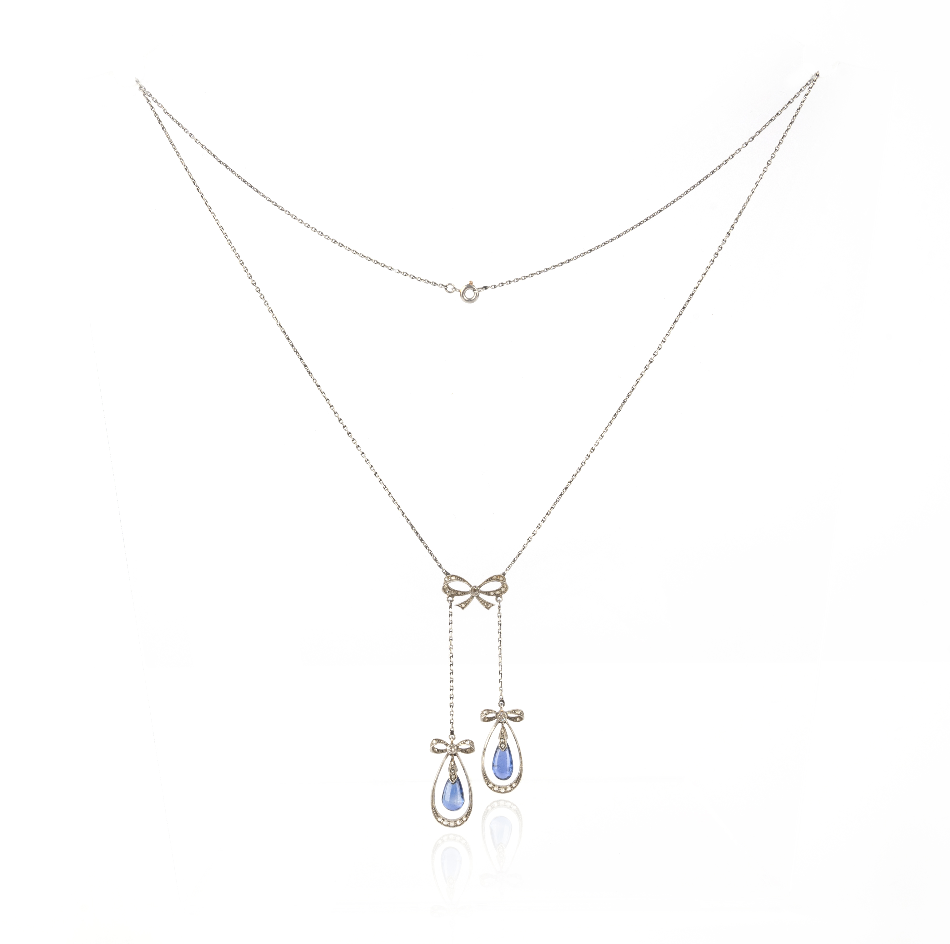 An Edwardian sapphire and diamond necklace, circa 1910, of negligée design, composed of a bow