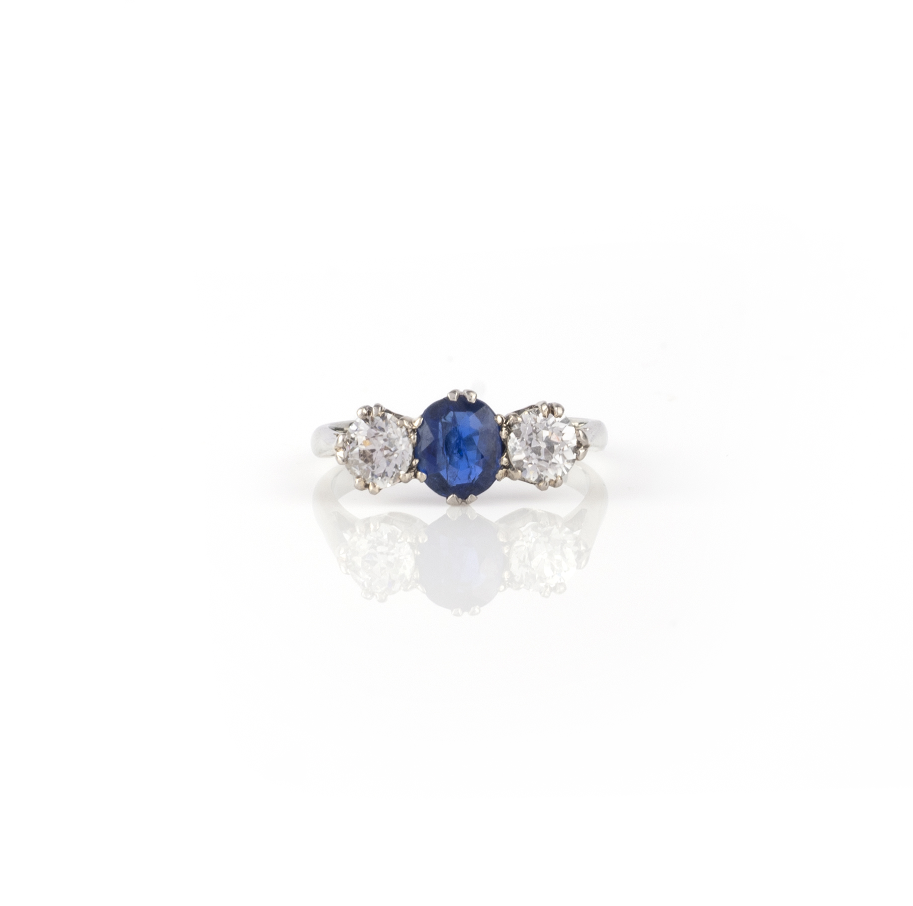 A sapphire and diamond three stone ring, the oval-shaped sapphire set within old circular-cut - Image 2 of 2