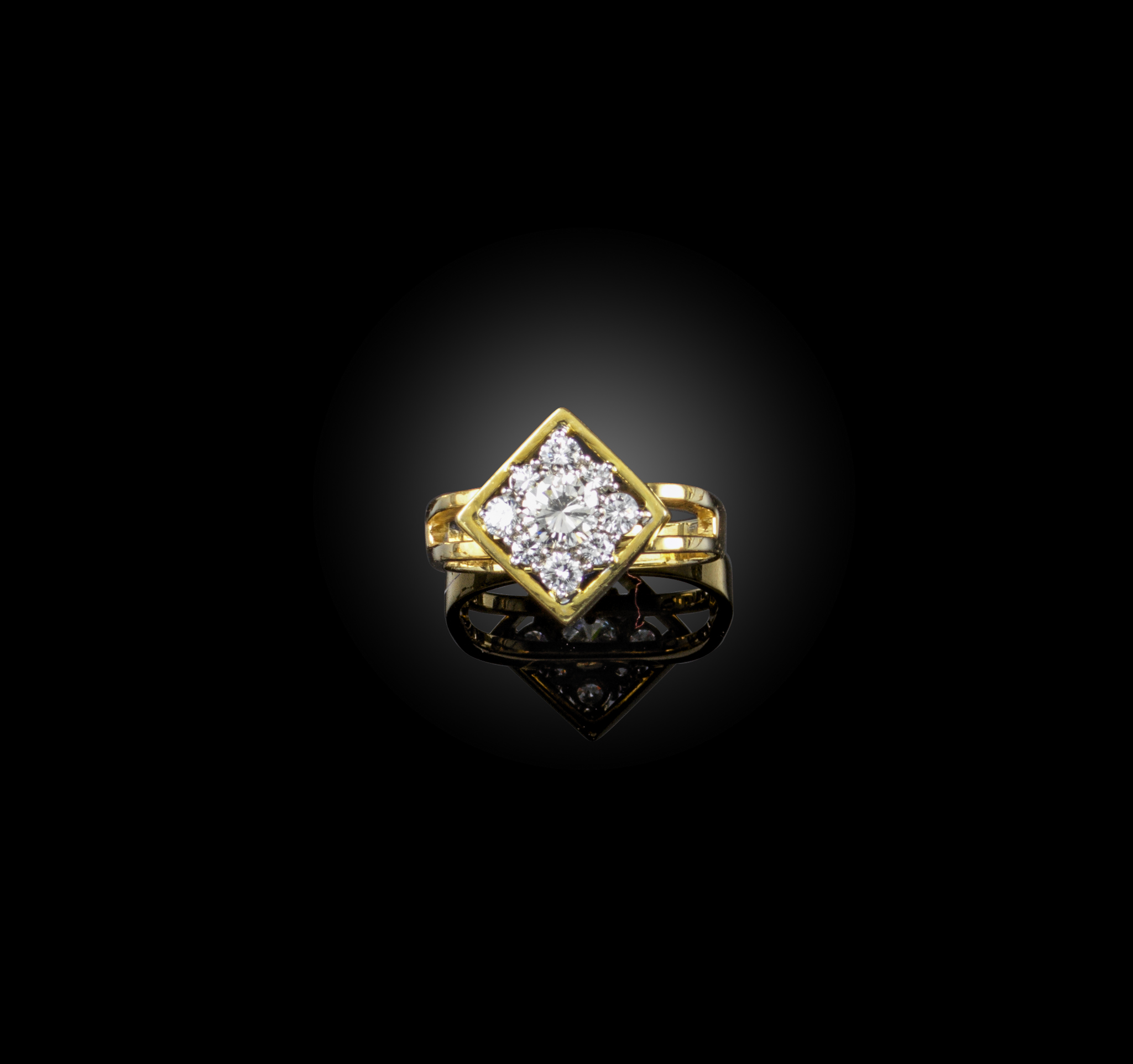 A diamond cluster ring, set with graduated round brilliant-cut diamonds within a square polished