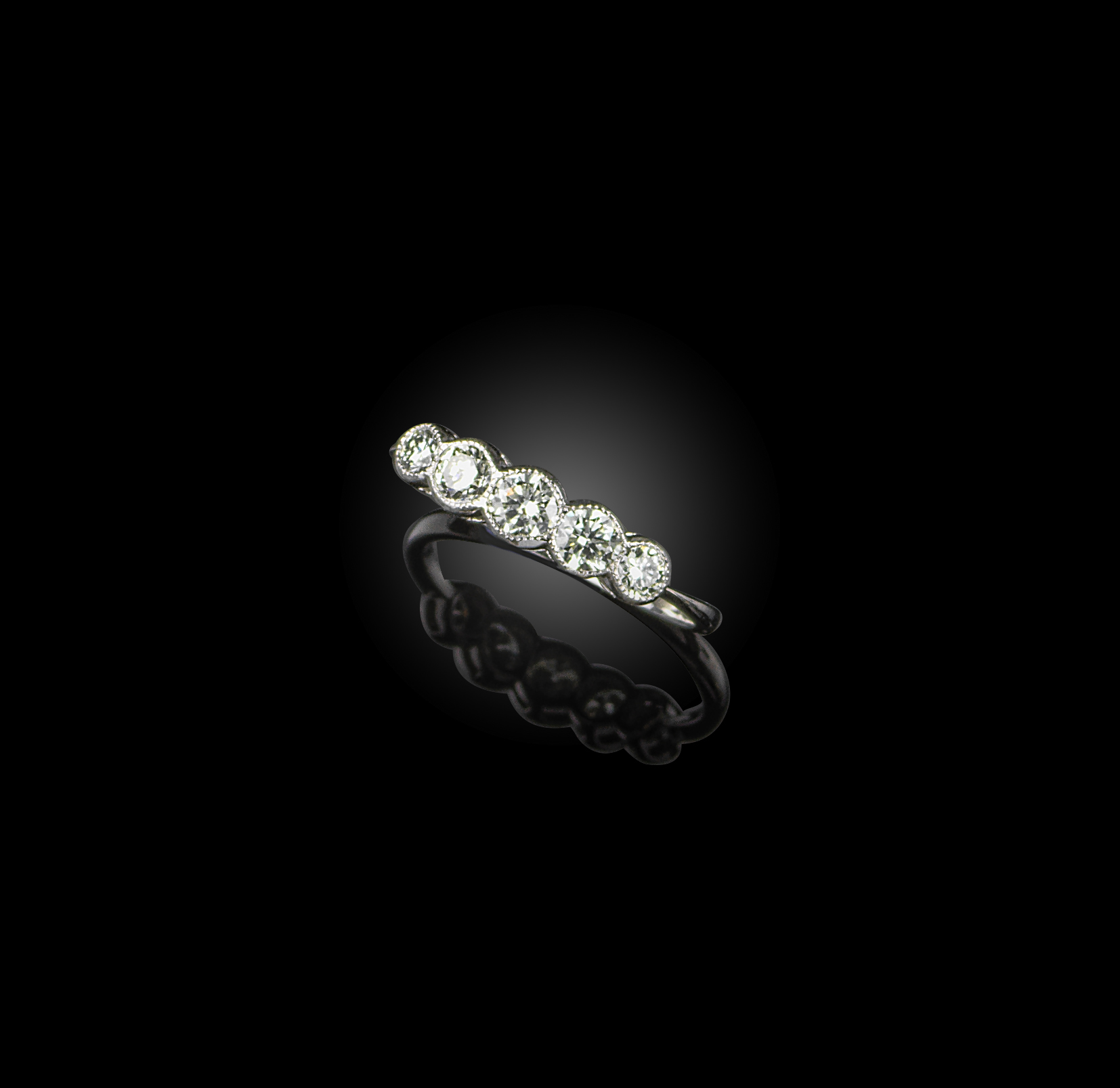 A five-stone diamond ring, set with brilliant-cut diamonds totalling 0.75 carats in millegrained