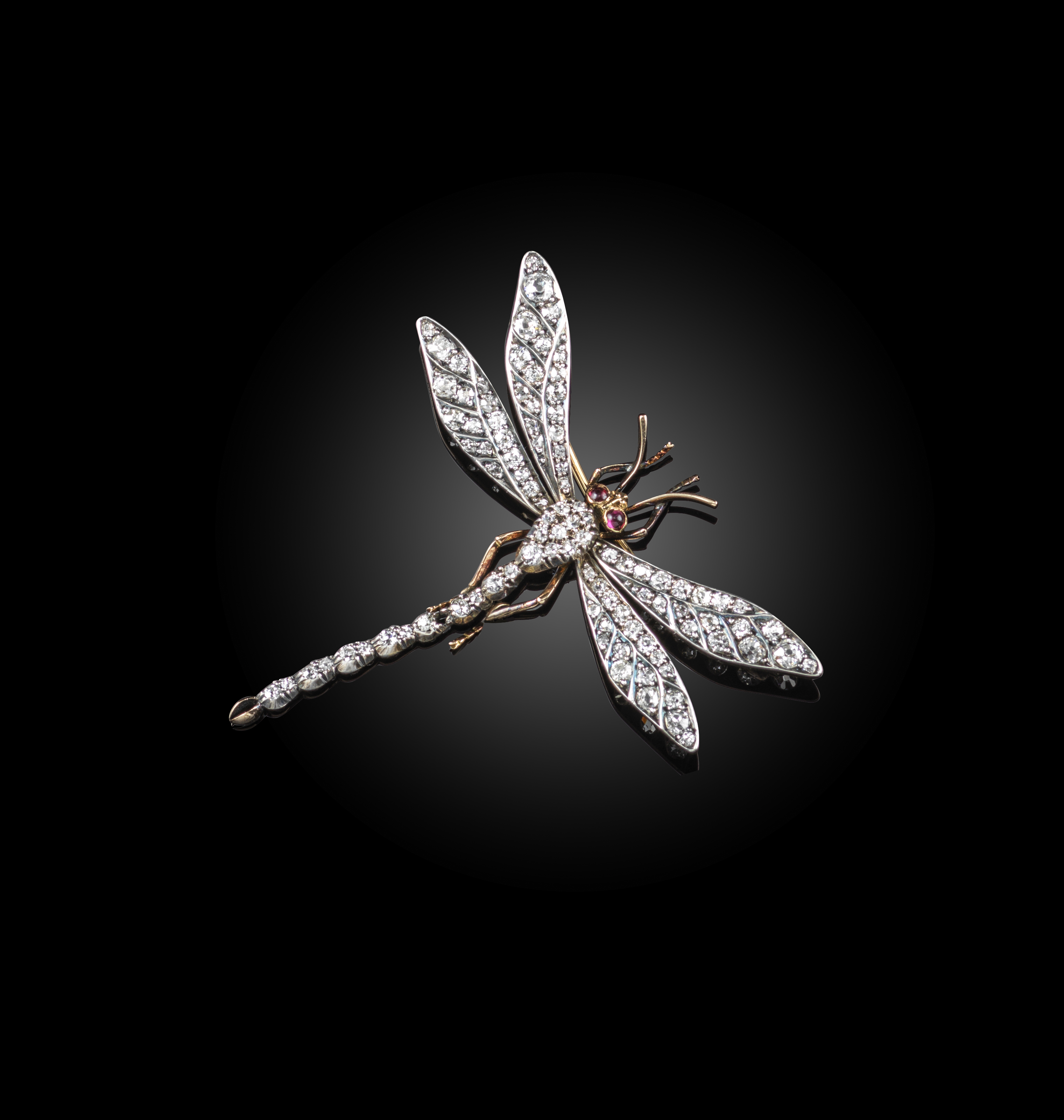A late Victorian diamond-set dragonfly brooch, set overall with graduated old cushion-shaped