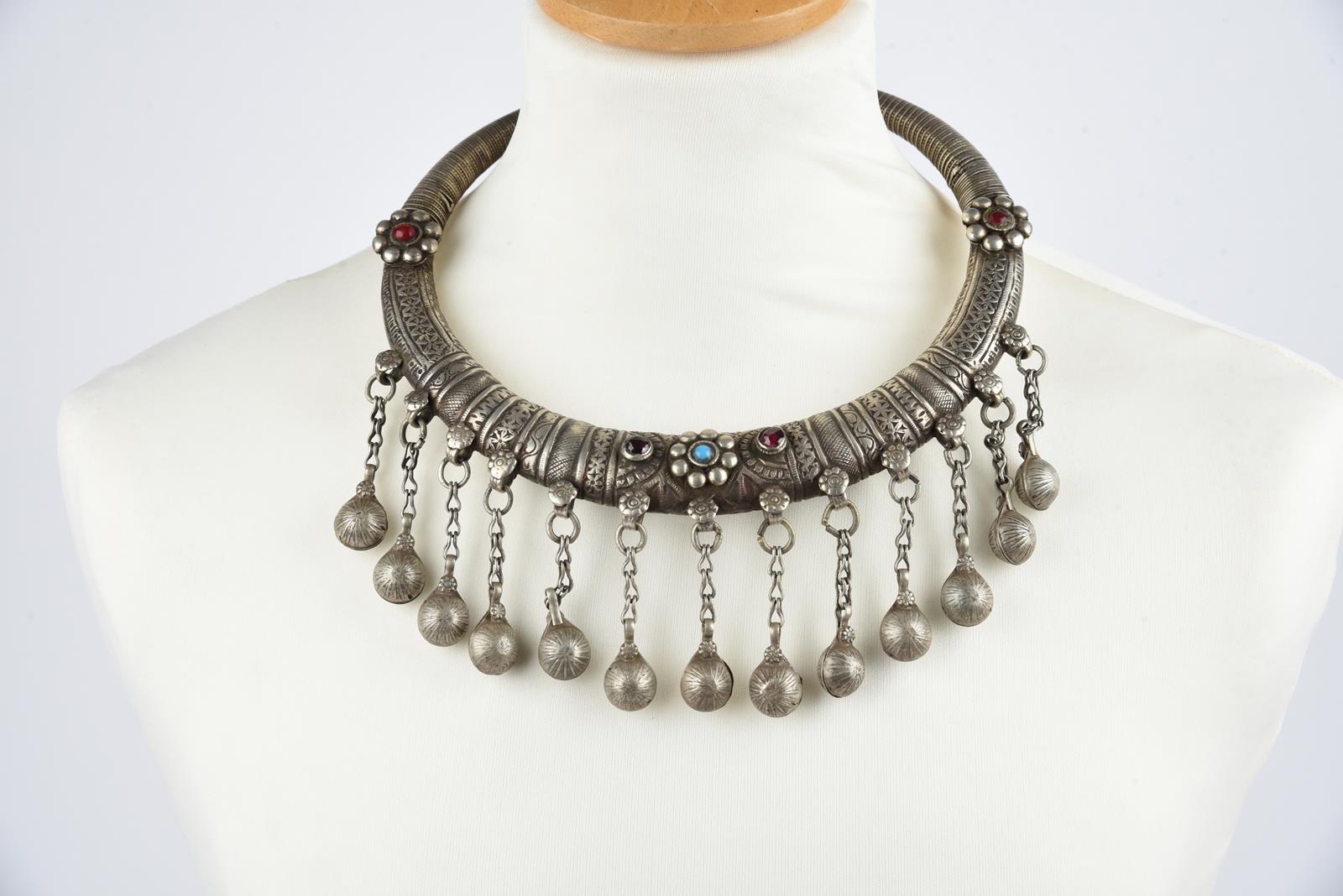 Three Nuristan torques silver coloured metal with applied blue stone and red and blue glass beads, - Image 17 of 19
