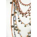 Five Naga necklaces Nagaland coloured glass beads, brass spiral disc pendants, brass convex disc