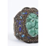 A Chinese hinged bracelet silver coloured metal and enamel with an inset jade carving of