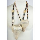 Two Naga necklaces Nagaland with chank shell pendants with punch dot decoration of three figures and