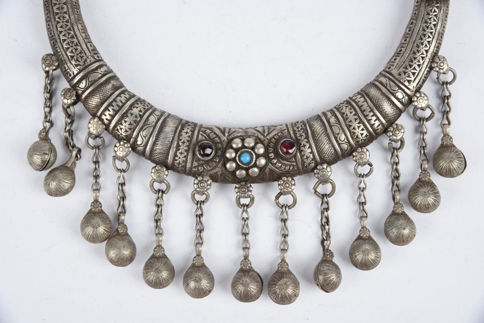 Three Nuristan torques silver coloured metal with applied blue stone and red and blue glass beads, - Image 4 of 19