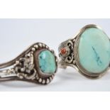 λTwo Tibetan bracelets silver coloured metal and inset turquoise, one with dragons and lion heads,