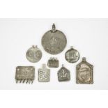 Eight Hindu plaque amulets India silver coloured metal, including - 1. circular, stamped a figure on