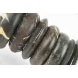 Four Dogon bracelets Mali stone, one with metal strap repairs, the largest 12.5cm diameter, and