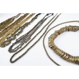 Seven Indian brass necklaces including a single, a triple and a quadruple bead type, two with
