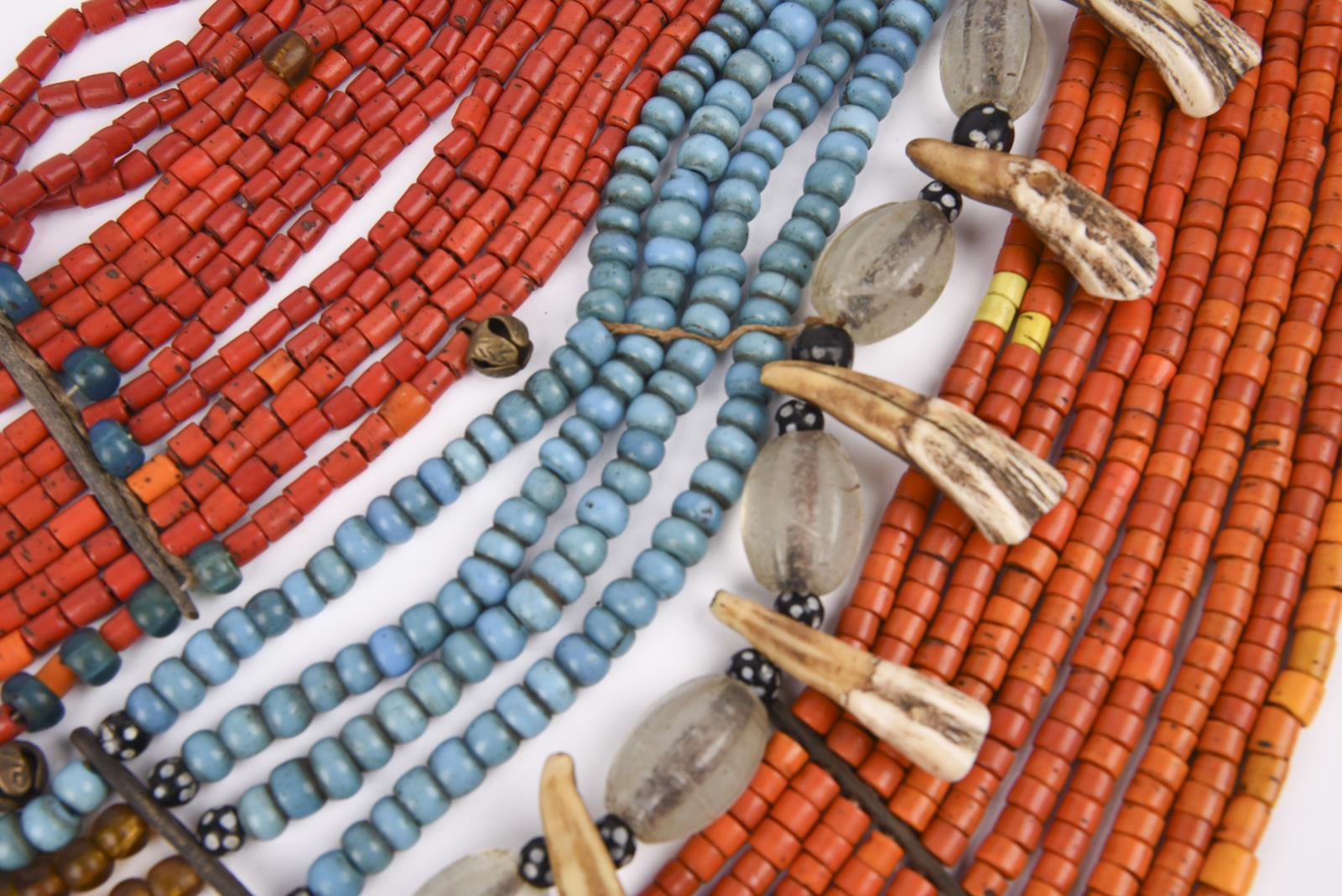 Three Naga necklaces Nagaland coloured and clear glass beads, brass and bone spacers, pig teeth
