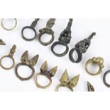 Sixteen African brass rings Mali and Ivory Coast including eight with figures, a bird, a