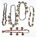 Five Nepal necklaces two with various brass pendants, including trumpets, discs, squares with