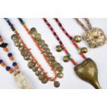 Four Naga necklaces Nagaland with glass and shell beads, including one with twenty six spiral