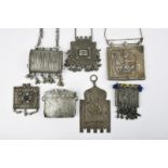 Seven Indian amulets silver coloured metal, including four boxes, one repousse decorated Durga on