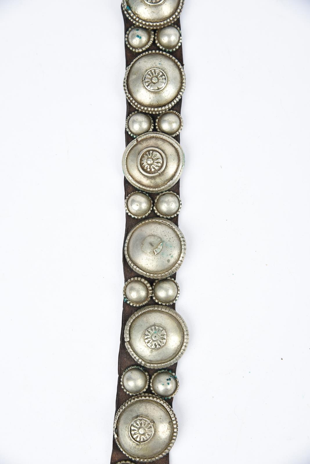 λA Bedouin amulet chest ornament cloth with numerous sewn on amulets and beads, 62cm long, and three - Image 12 of 27