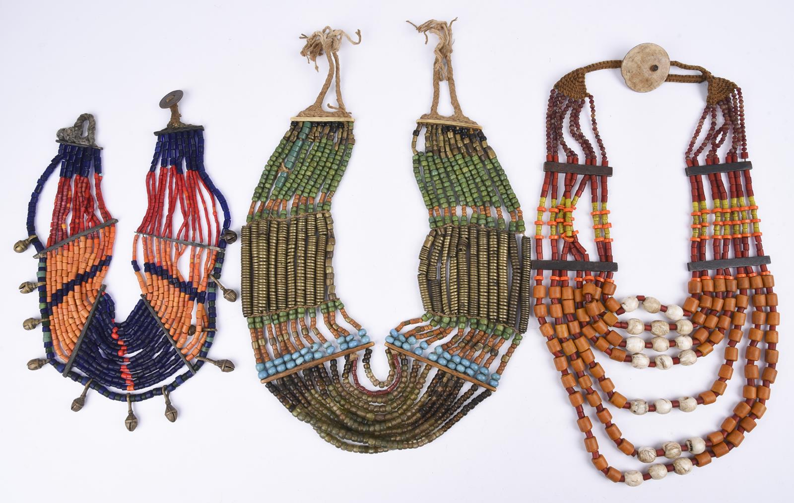 Three Naga necklaces Nagaland coloured glass beads, brass, shell and fibre, one hung with brass