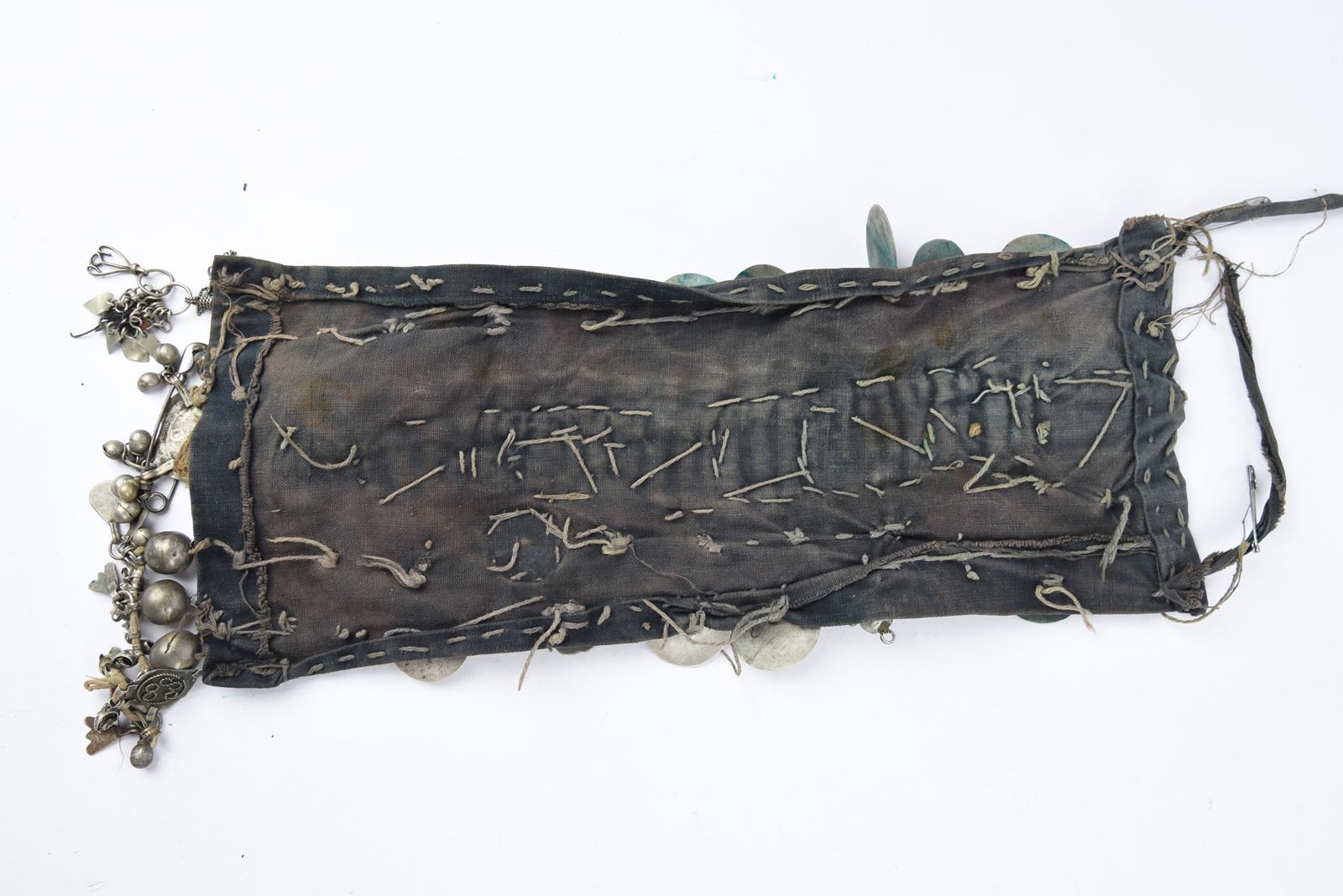 λA Bedouin amulet chest ornament cloth with numerous sewn on amulets and beads, 62cm long, and three - Image 9 of 27