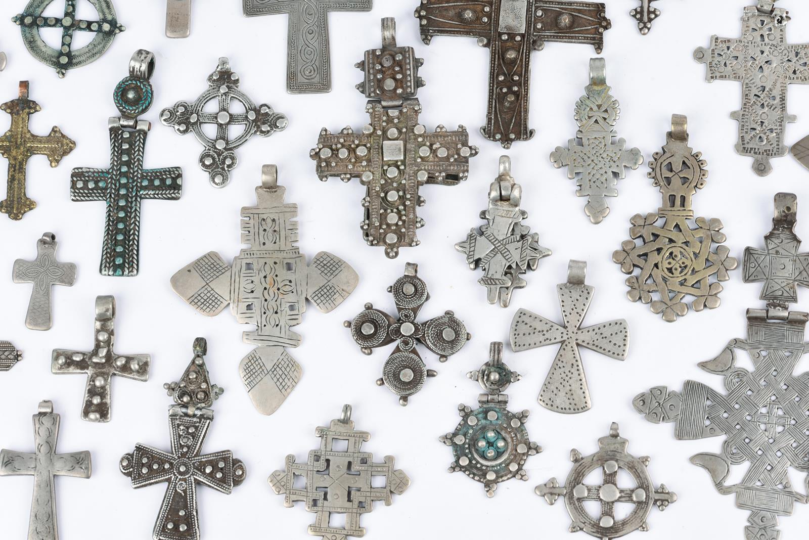 Twenty nine Ethiopian Coptic cross pendants silver coloured metal, one brass, twelve hinged with one