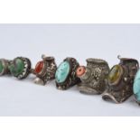 λEleven Tibetan rings silver coloured metal with turquoise and coral, and engraved, chased and