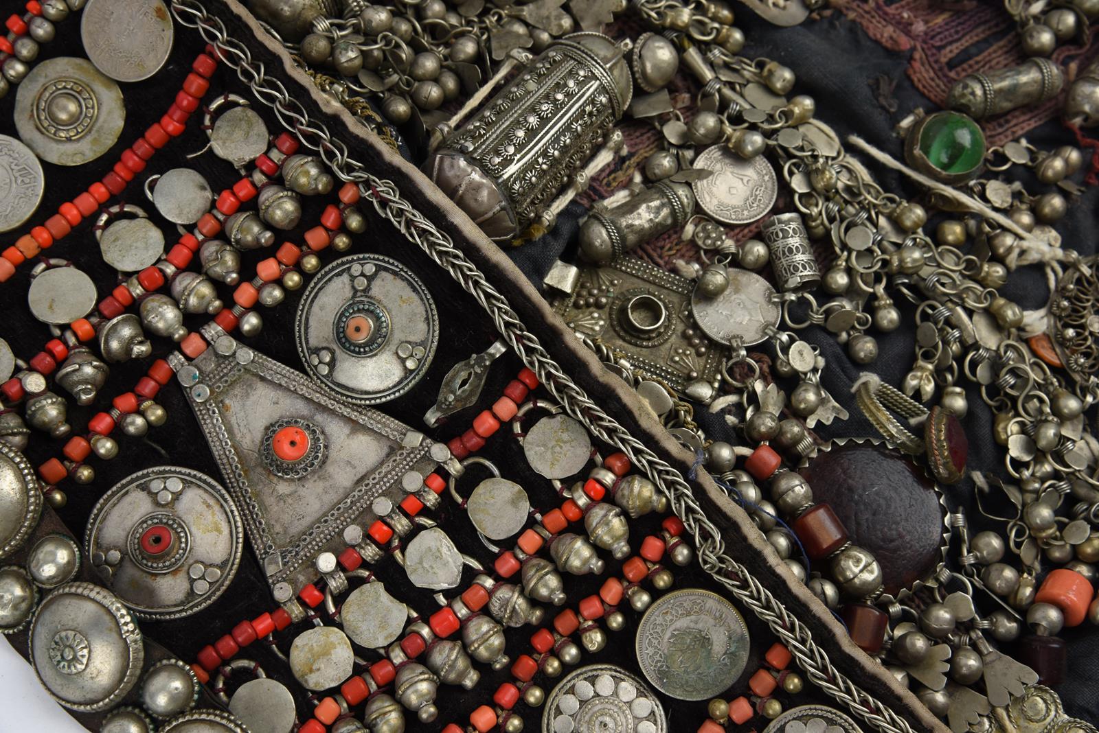 λA Bedouin amulet chest ornament cloth with numerous sewn on amulets and beads, 62cm long, and three - Image 3 of 27