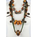 Four Himalayan bead necklaces glass, faux amber, brass, silver coloured metal, shell and Indian