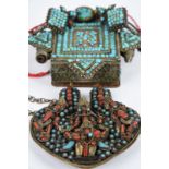 A Tibet amulet box silver coloured metal and tin with inset turquoise and gilt to the central panel,