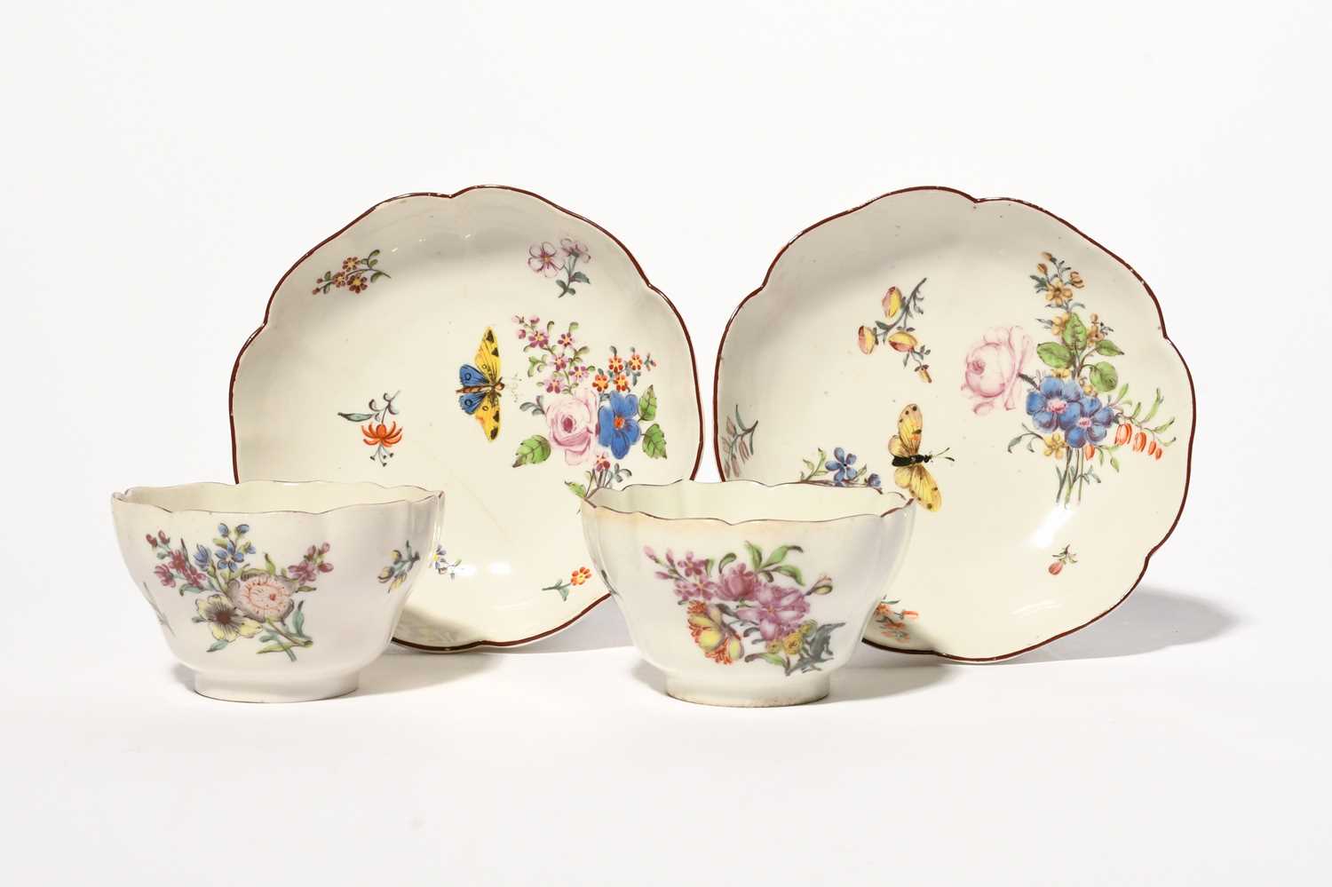 A pair of Chelsea teabowls and saucers, c.1754, of lobed hexafoil form, painted with sprays and