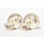 A pair of Chelsea teabowls and saucers, c.1754, of lobed hexafoil form, painted with sprays and