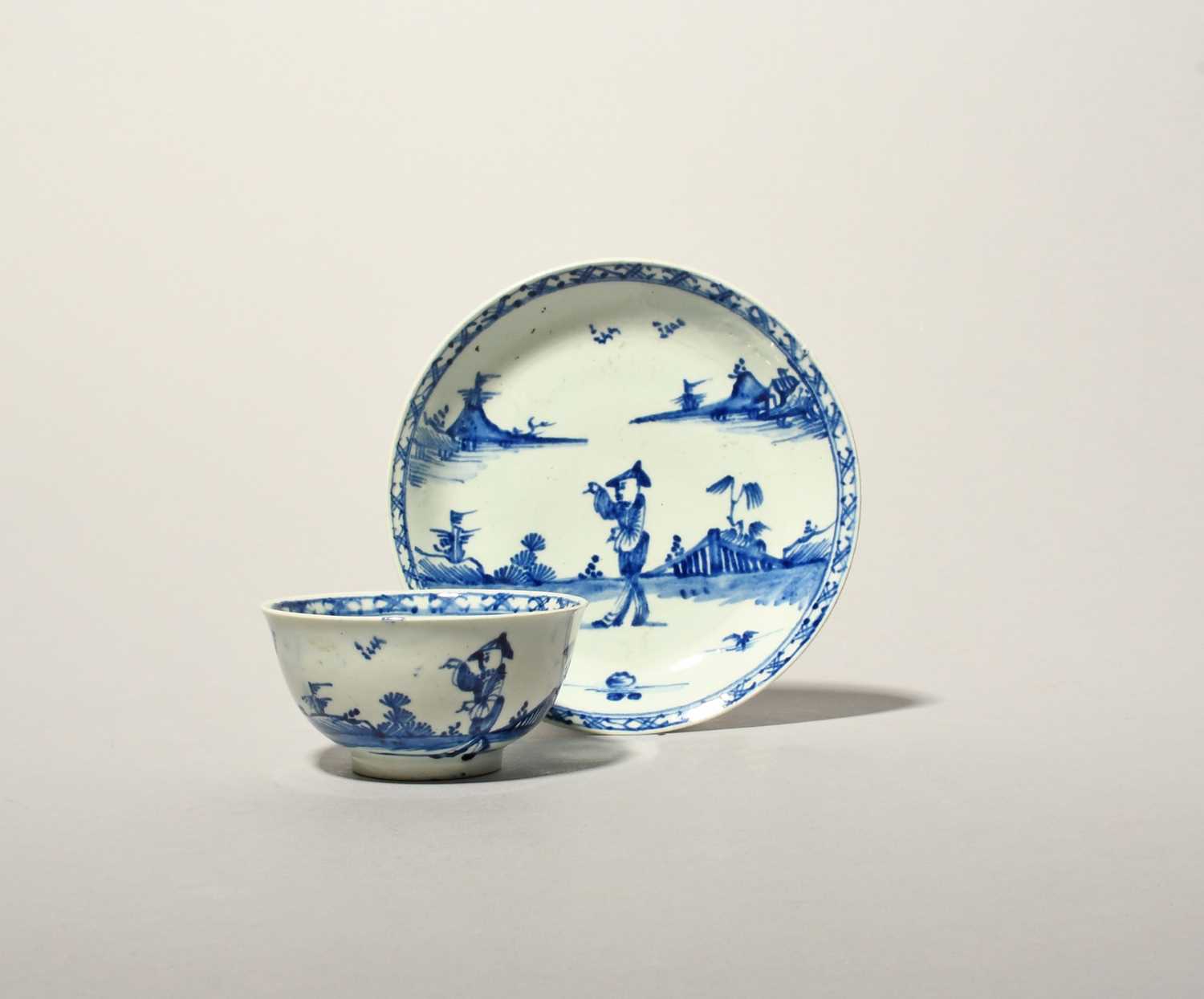 A Vauxhall blue and white teabowl and saucer, c.1755, painted in a strong blue with a Chinese figure