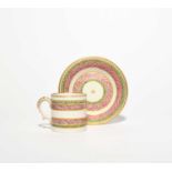 A Bristol coffee can and saucer, c.1775, painted with bands of pink scale decoration within leaf