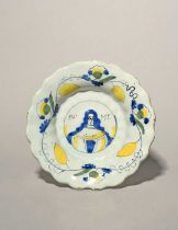 A small Delft lobed portrait dish, c.1685-89, painted in blue, black, green and yellow with the