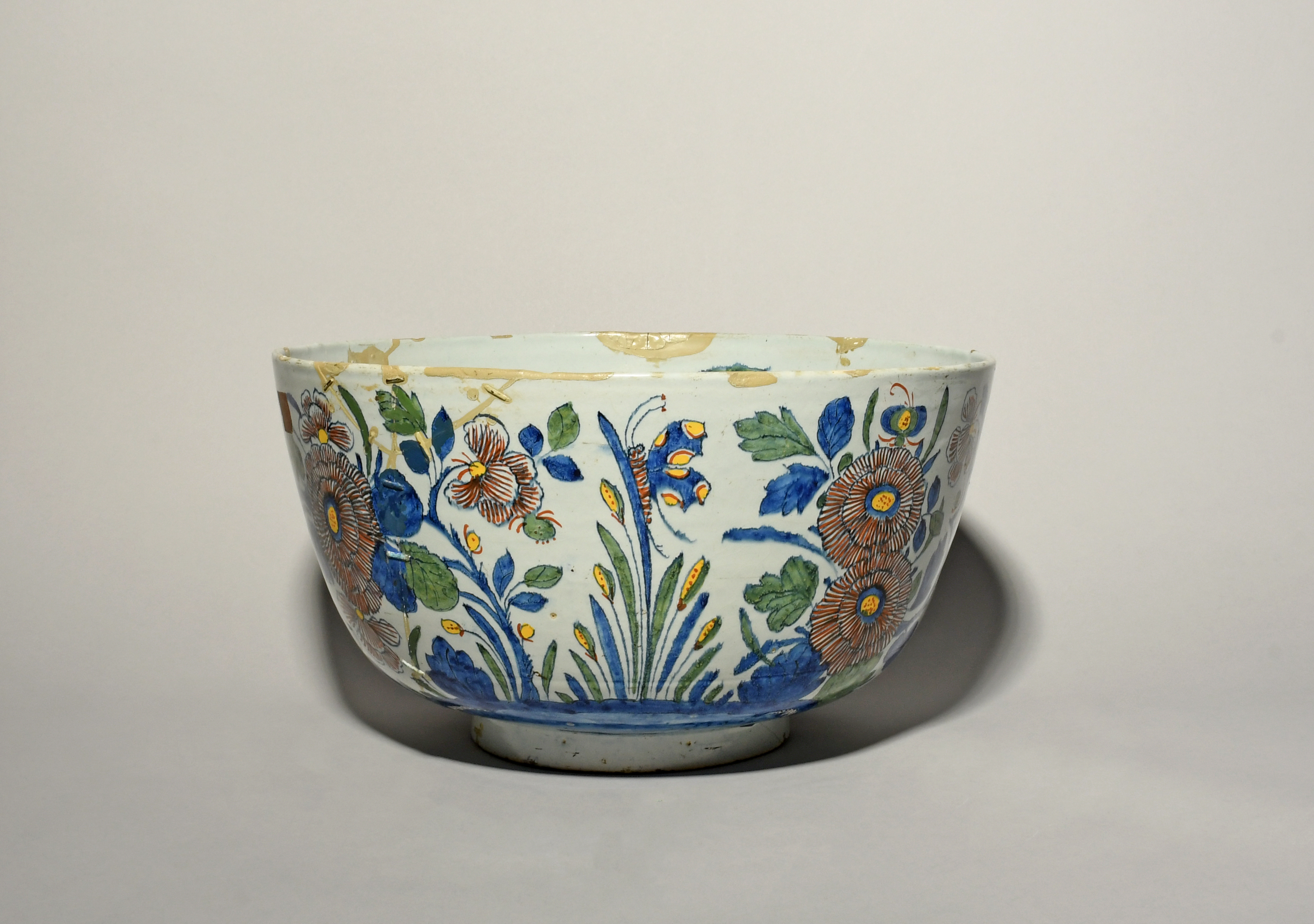A massive Delft punch bowl, 18th century, boldly painted in polychrome enamels with flowering plants - Image 2 of 3