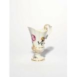 A Meissen helmet ewer, c.1740, finely painted with Holzschnitt Blumen, including a rose and