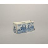 A small Liverpool delftware flower brick, c.1750, the rectangular form painted in blue with a
